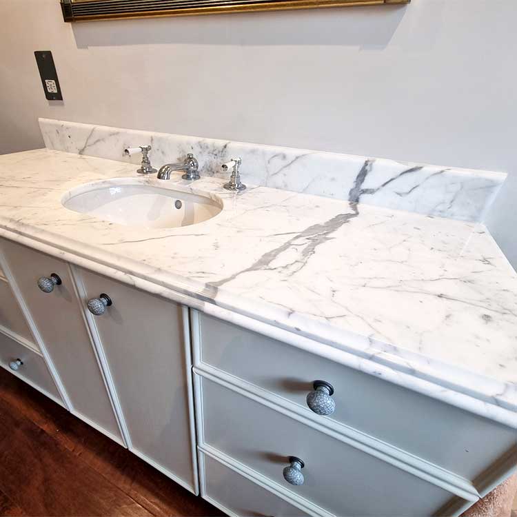 Carrara marble bathroom vanity top with Ogee edge detailing and small splashback by LBS Stone