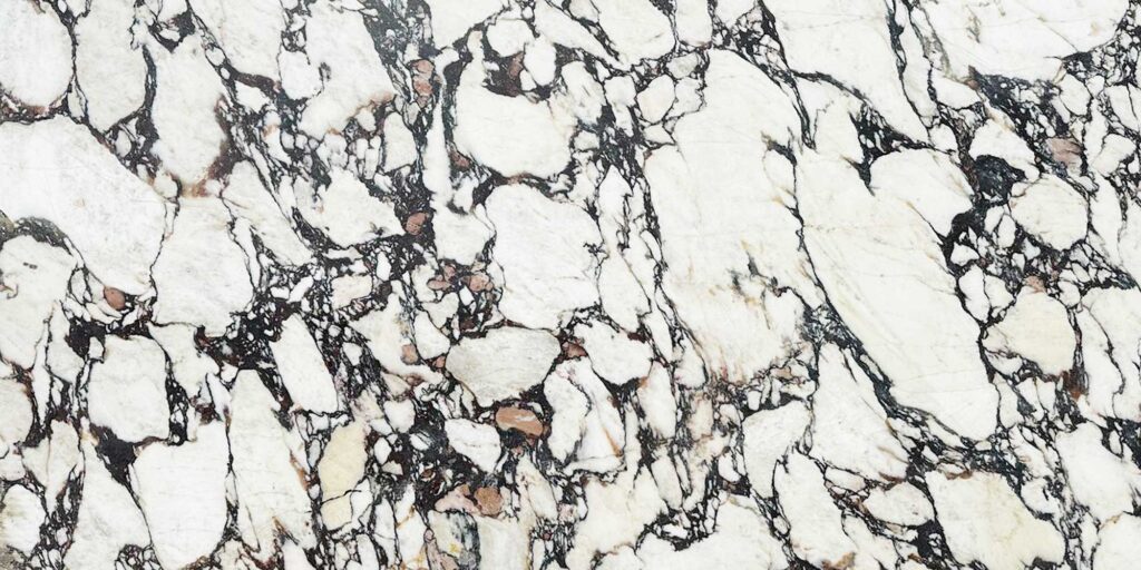 A Calacatta Viola white marble slab with circular reddish black veins