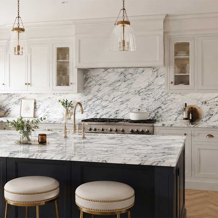 Luxury kitchen with white and grey veined Arabescato Corchia marble worktops and matching splashbacks